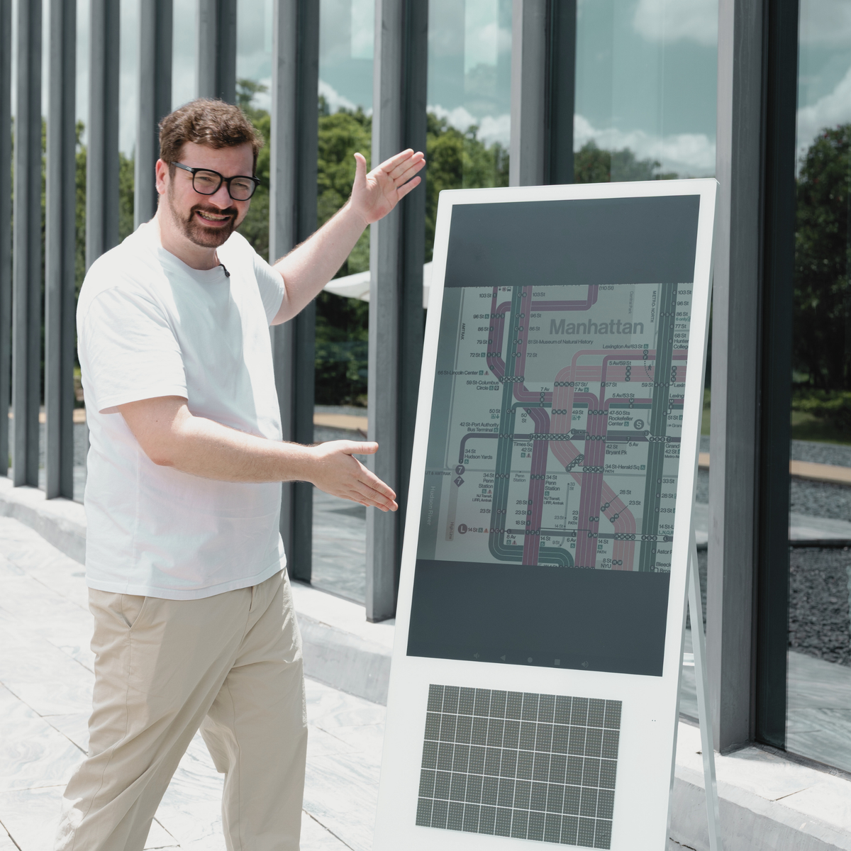43-inch RLCD kiosk in daylight outside a glass building, screen readable in direct sun