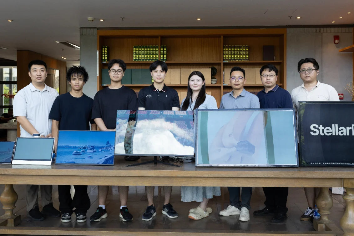 The Stellar Displays team standing behind a table of reflective display modules