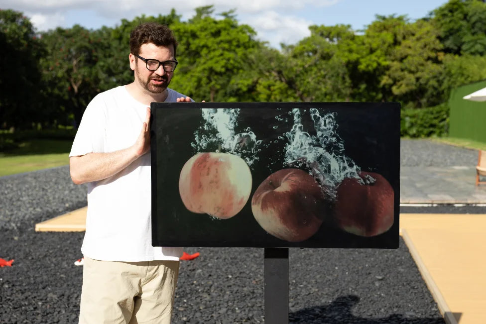 A large reflective display showing produce imagery outdoors